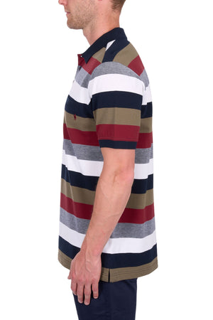 A man in a Thomas Cook Sean Polo—cotton pique with navy, white, olive, gray, and red wide stripes—stands in profile against a white background.