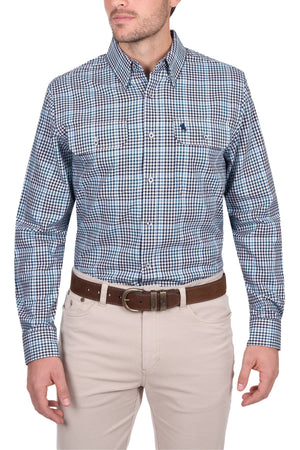 A man wears a blue and white checkered Thomas Cook Stephen Shirt, a 100% cotton men's work shirt with two chest pockets, paired with light pants and a brown belt. His face is partially out of frame.