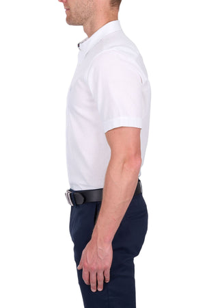 A man in profile wears the Thomas Cook TC Linen Short Sleeve Shirt—an effortless summer essential—paired with a black belt and dark navy pants against a white background.