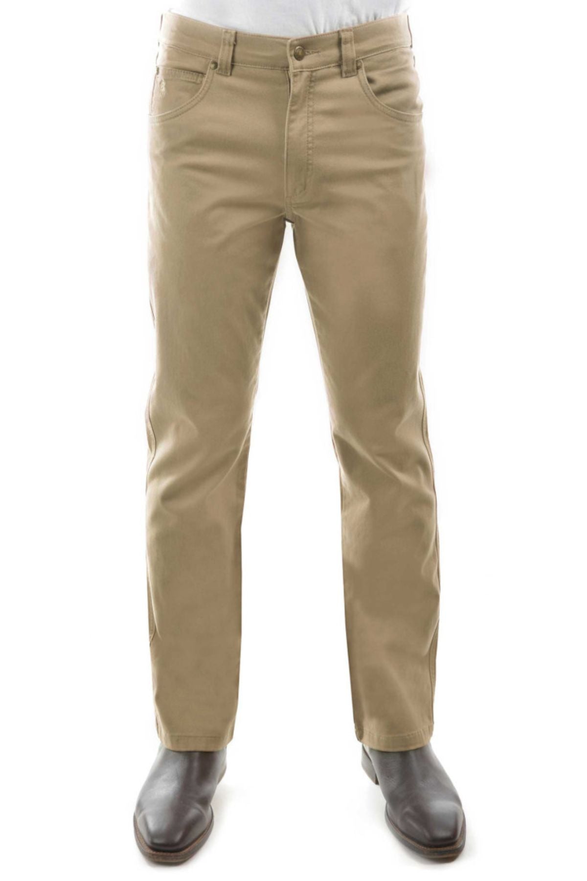 A person wears the Thomas Cook Tailored Moleskin Jean in tan, styled with dark brown boots. They stand against a white background, cropped at the waist with their face not visible.