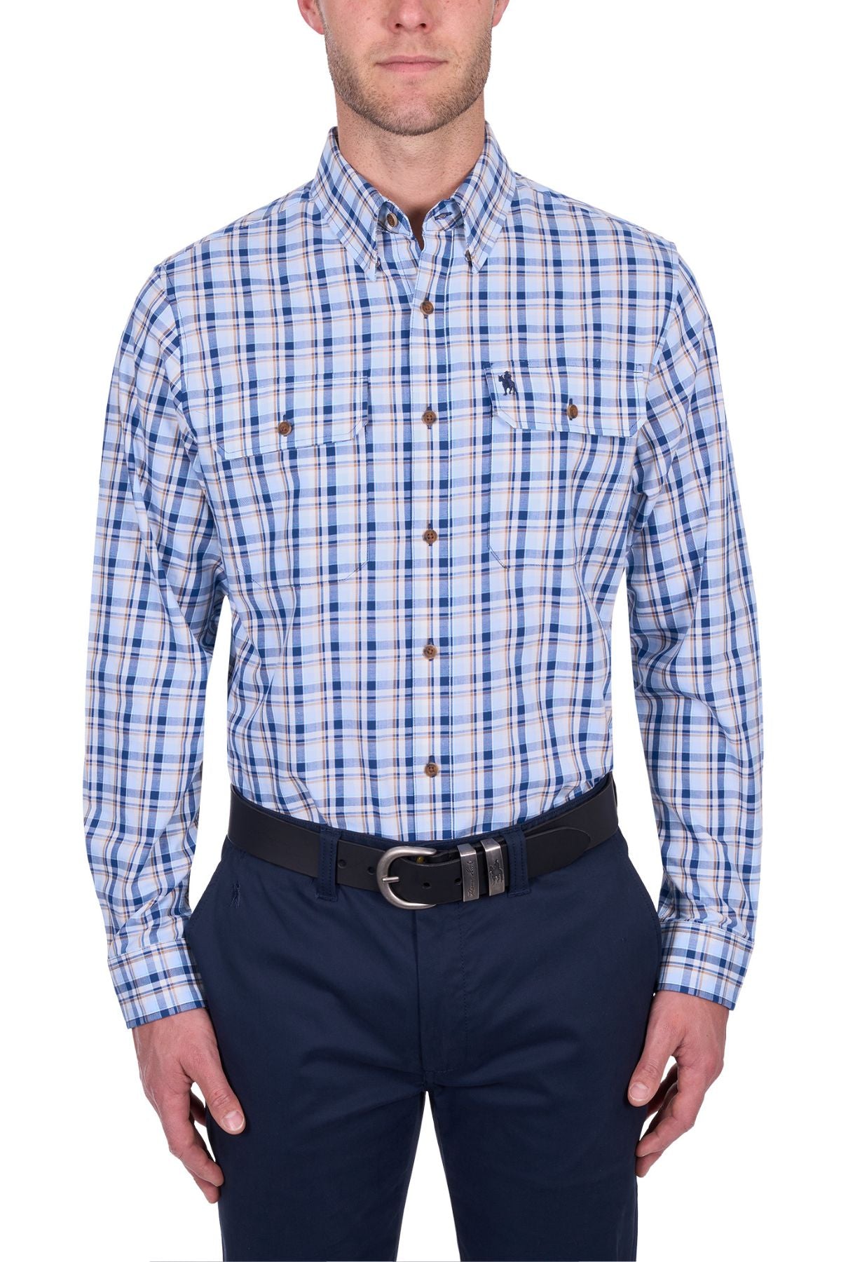 A man wearing a blue, white, and tan Thomas Cook Thomas Shirt with long sleeves, dark blue pants, and a black belt stands against a white background.
