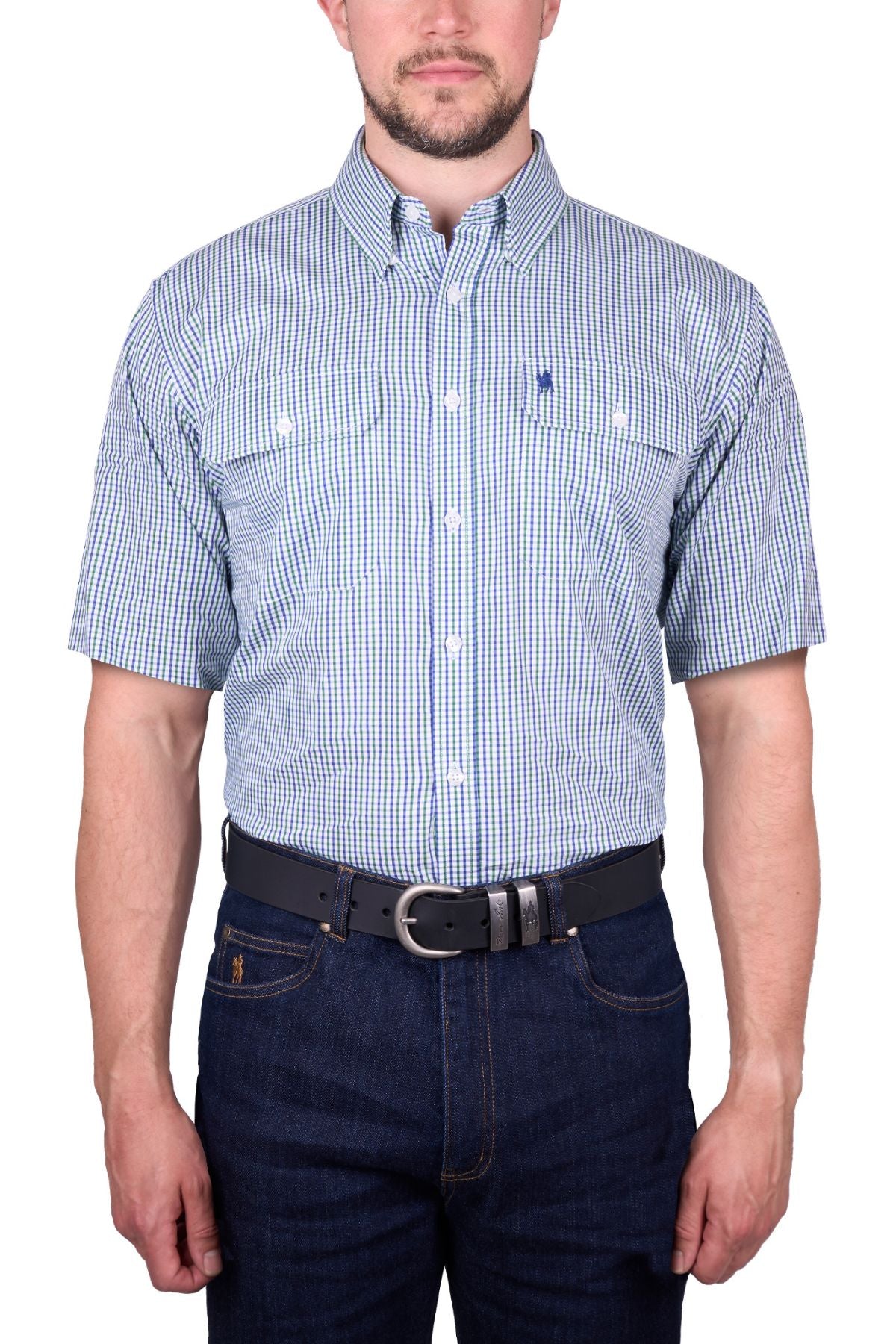 A man wears a Thomas Cook Wentworth Short Sleeve Shirt in blue and white checks, paired with dark blue jeans and a black belt, standing against a white background.