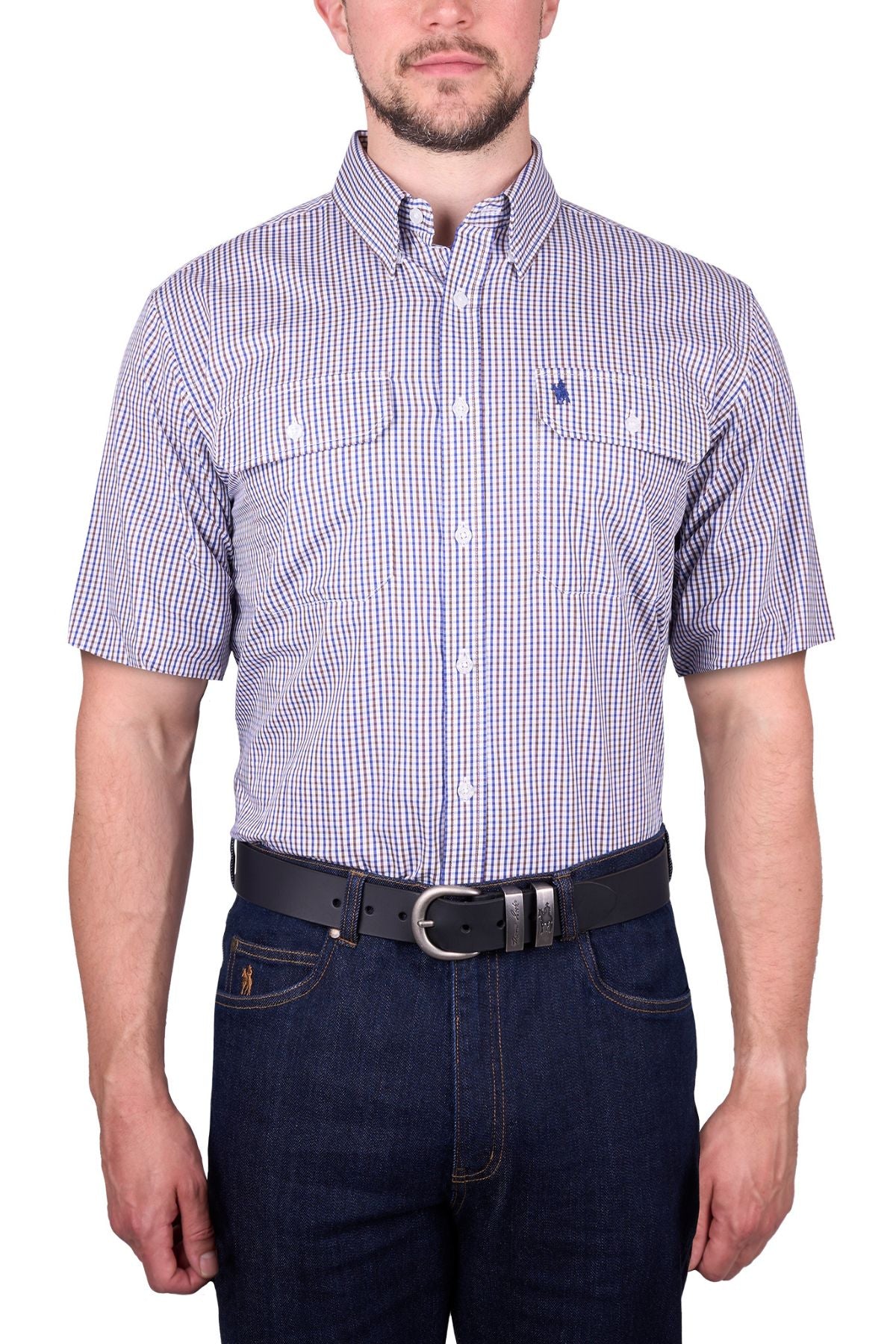 A man stands against a white background wearing the Thomas Cook Wentworth Short Sleeve Shirt in blue and white checks, paired with dark blue jeans and a black belt. The classic-fit cotton shirt's design complements his partially visible face.