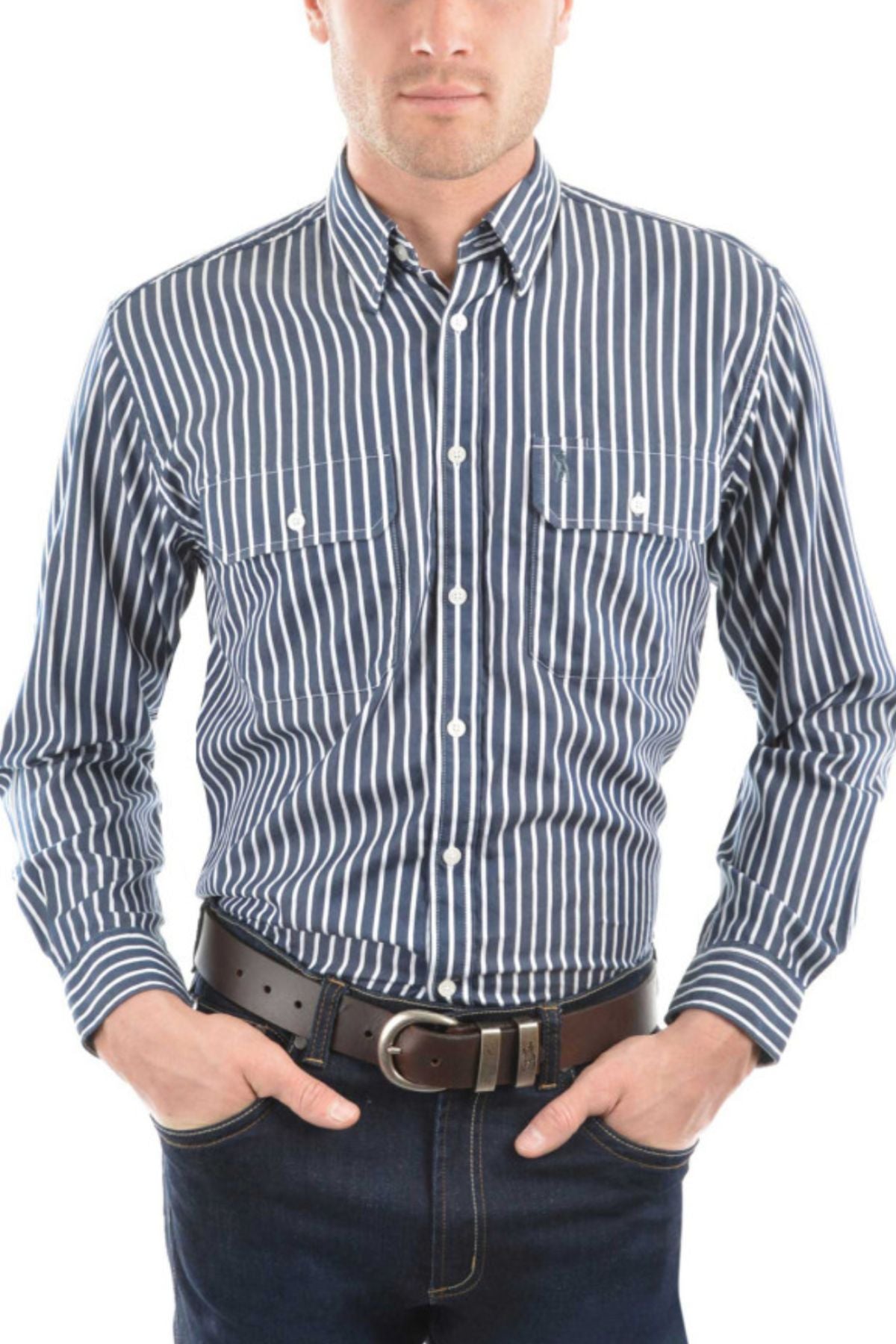 A man wears the Thomas Cook Winton Shirt—a blue and white striped 100% cotton men’s work shirt with two chest pockets—paired with dark jeans and a black belt, standing hands-in-pockets against a white background.