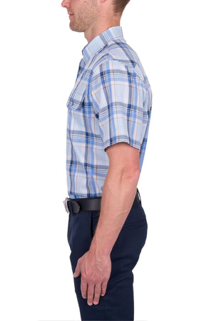 A man in profile wears the Thomas Cook Brian Short Sleeve Shirt—100% cotton, blue and white plaid—tucked into dark navy pants with a black belt, set against a white background.