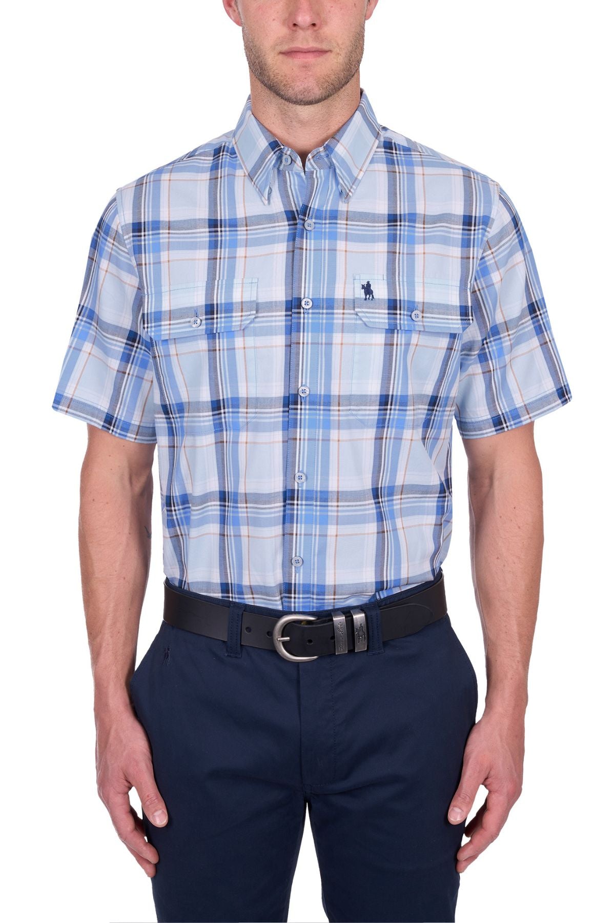 A man wears the Thomas Cook Brian Short Sleeve Shirt—100% cotton, blue and white plaid, button-up with two chest pockets—paired with navy pants and a black belt, against a white background. Ideal for everyday wear.