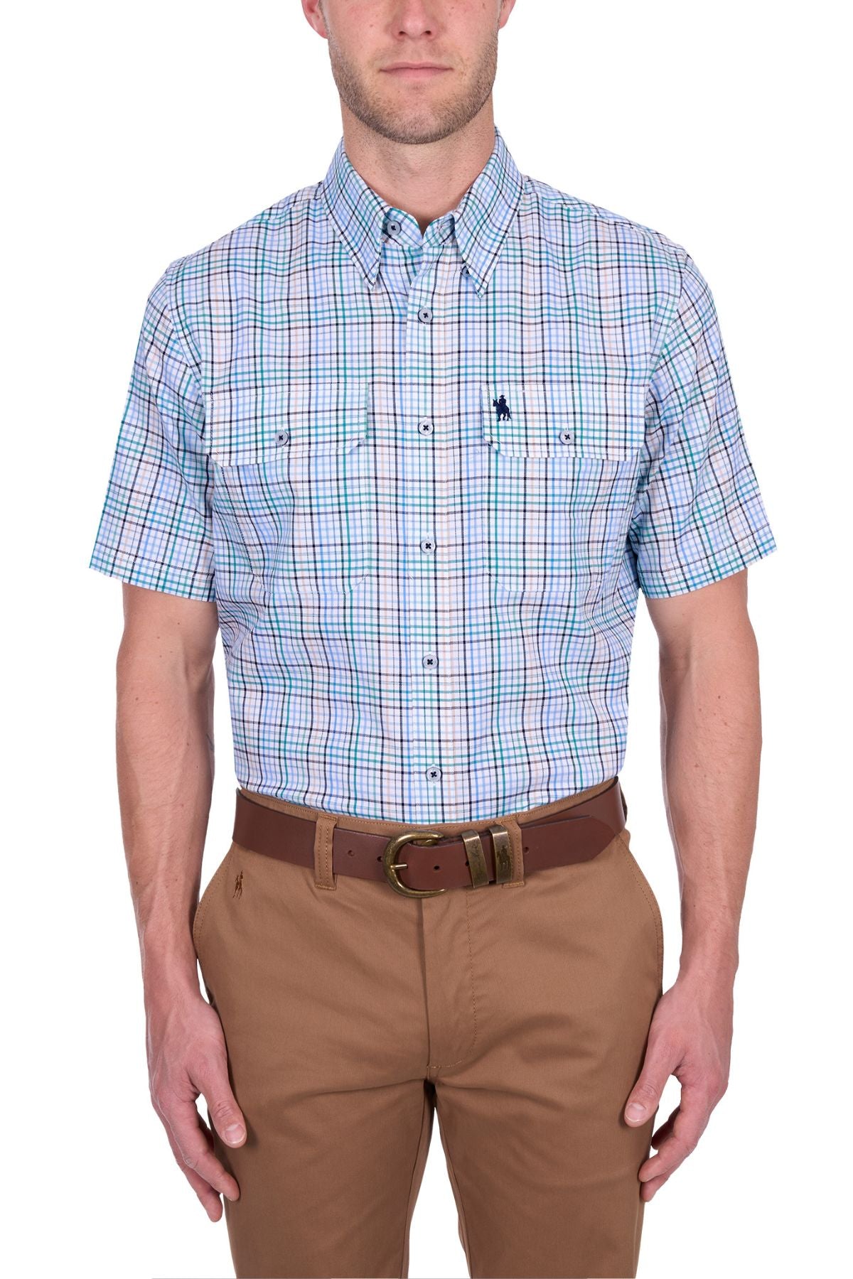 A man wearing the Thomas Cook Matt Short Sleeve Shirt in blue, green, and white plaid, tucked into tan pants with a brown belt, stands against a white background.