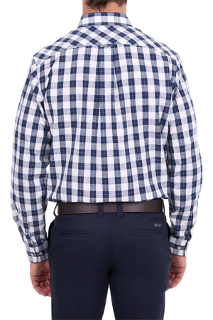 A man is shown from the back wearing the Thomas Cook Ezra Shirt—a blue and white cotton check shirt—tucked into dark blue pants with a black belt.