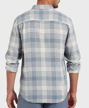 A person in an Academy Brand Yosemite Shirt, light blue and white plaid with rolled-up sleeves, viewed from the back. Crafted in a casual style from a linen-viscose blend, it stands out against the plain background.
