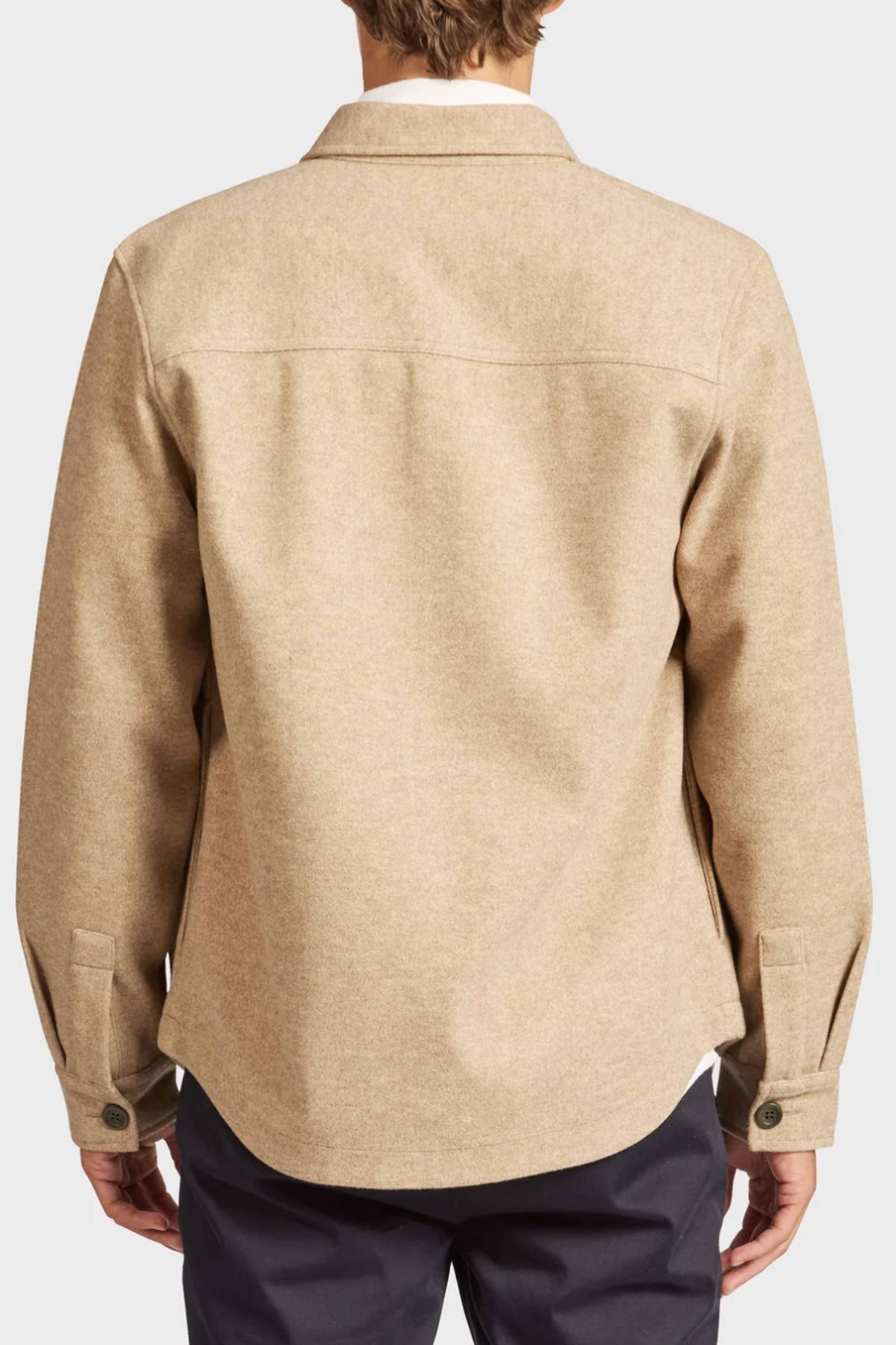 A person is shown from the back wearing a light brown Academy Brand Lloyd Overshirt with buttoned cuffs and black pants. This men's overshirt has a relaxed fit, collared design, and is free of visible patterns or logos.