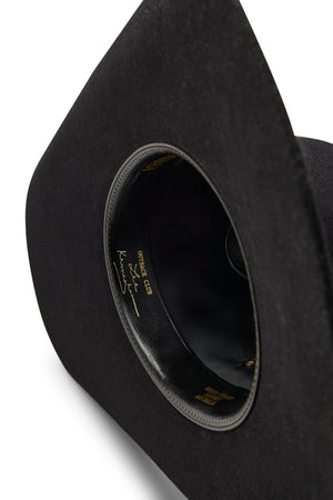 A close-up of the inside of a black Akubra Outback Club hat, featuring gold lettering and Australian country star Lee Kernaghan’s signature along the inner band.
