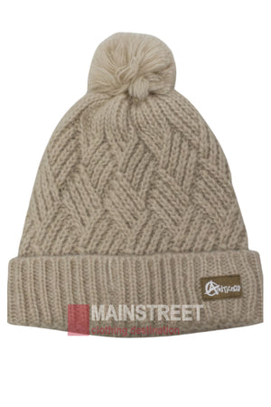 The Anticorp Ladies Herringbone Beanie is beige with a folded brim, a zigzag herringbone pattern, a pom-pom on top, and features a small brown tag with white lettering on the brim.