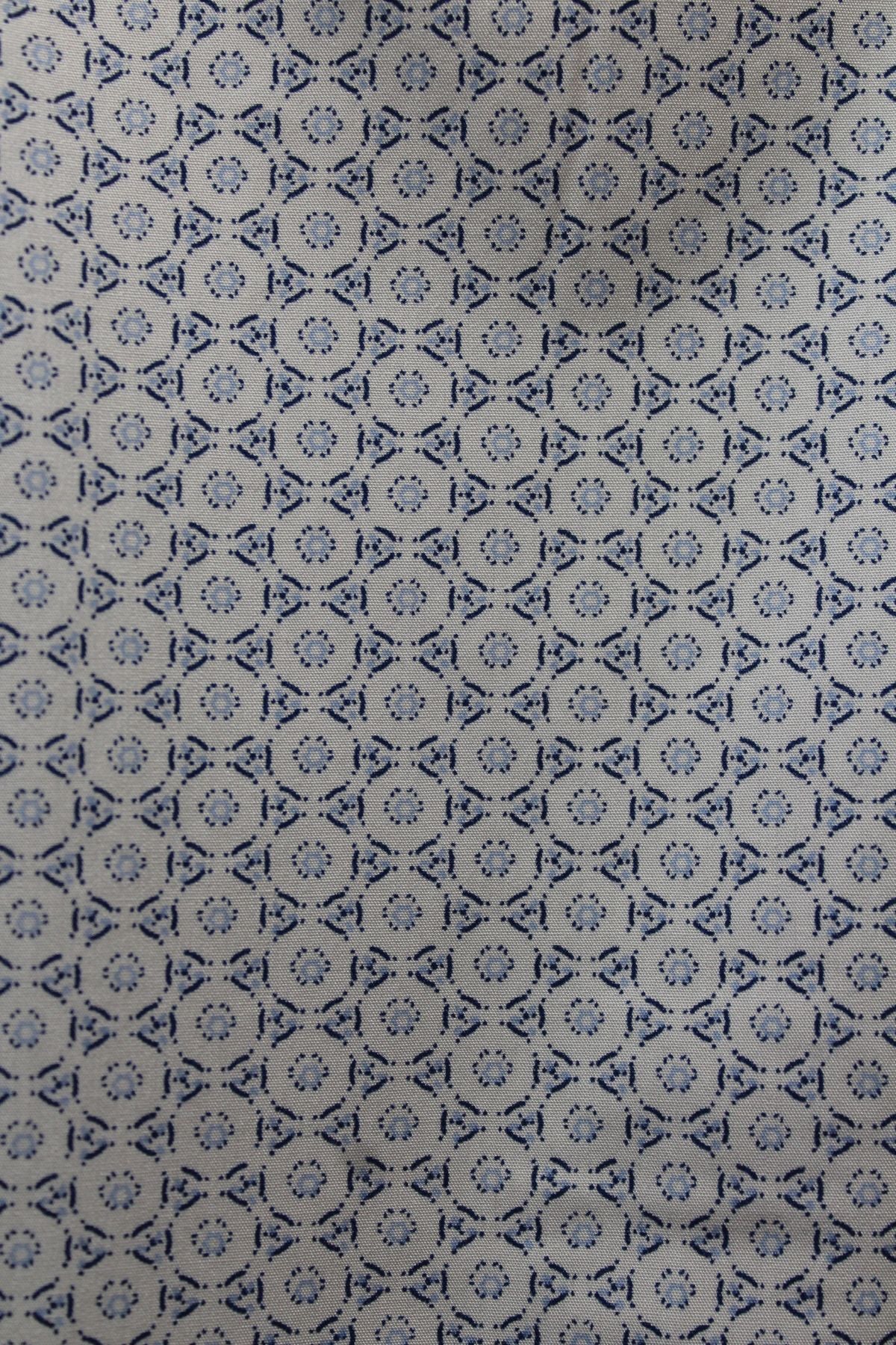 A close-up of the Back Bay Bamboo Soft Touch Print Short Sleeve Shirt, featuring a blue geometric pattern of circles and diamonds on light beige, made from a soft polyester cotton blend.