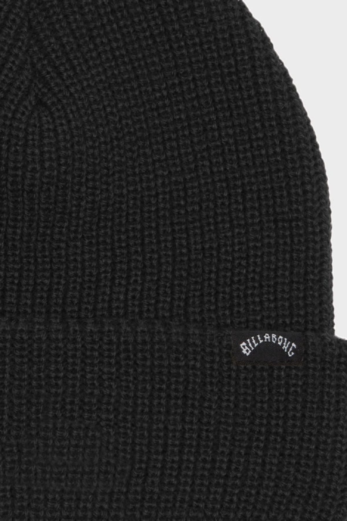 A close-up of the Billabong Arcade Beanie in black, featuring a Skull Fit, acrylic gauge rib knit construction, and a small curved Billabong logo tag sewn on the front.