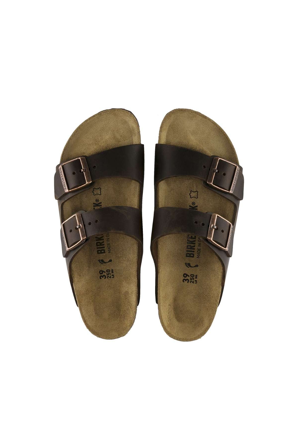 A pair of Birkenstock Arizona sandals in brown, featuring two adjustable buckle straps on each foot, set against a white background. The beige soles have visible branding and size information printed in black on the footbeds.