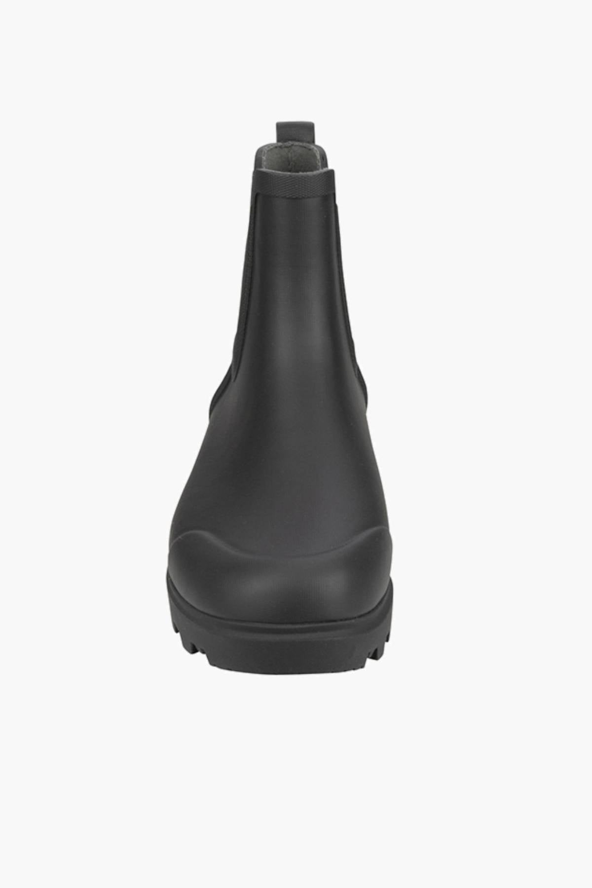 Front view of a single BOGS Holly Chelsea Waterproof Boot in black with a rounded toe, BLOOM Algae Footbed, textured sole, and pull tab at the top, shown on a white background.