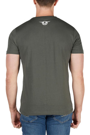 A person wearing a Bullzye Original Tee in classic fit, short sleeves, olive green with a small white logo on the upper back, paired with blue jeans, is seen from behind against a plain white background.