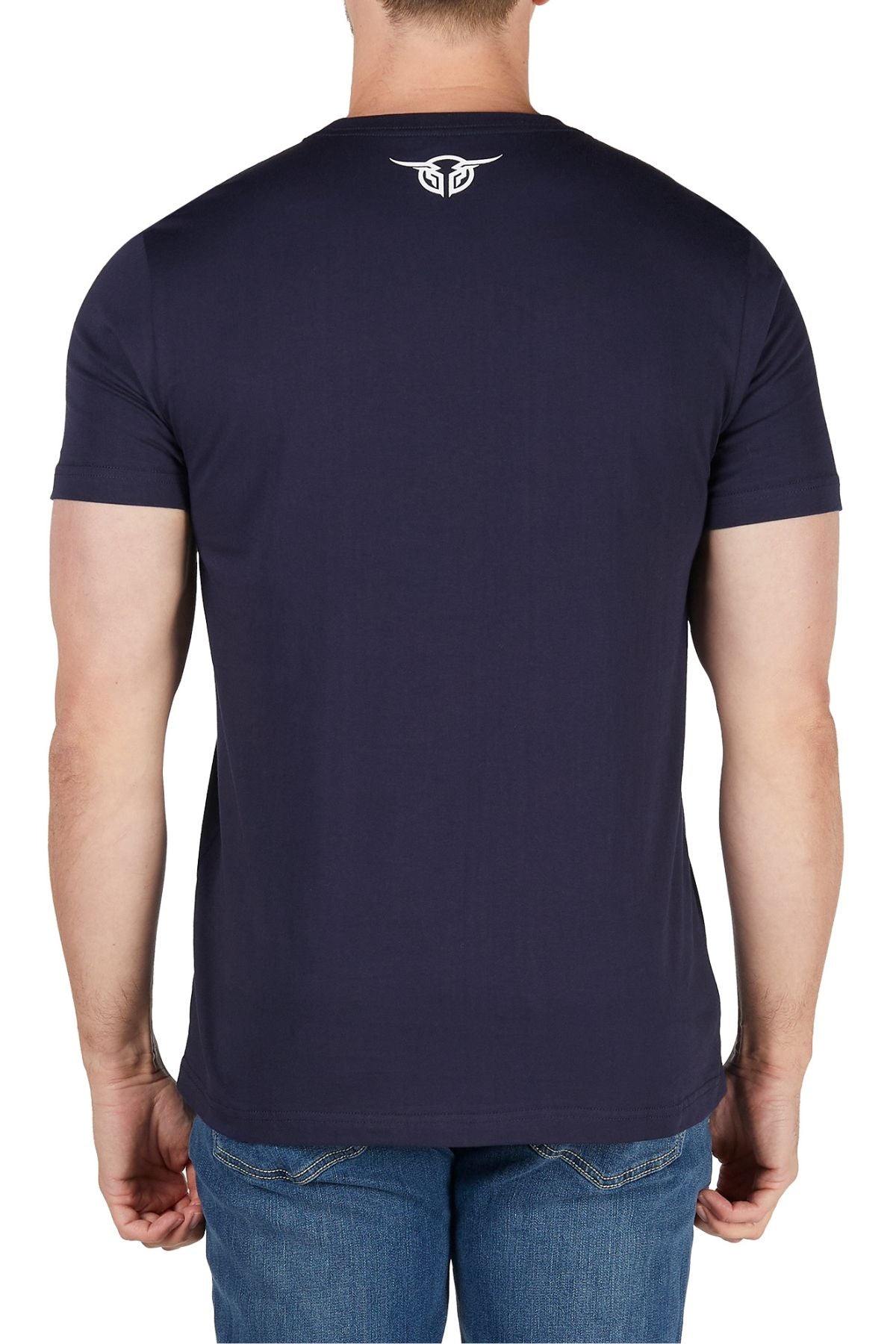 A person wearing the Bullzye Dusk Tee—a 100% cotton jersey shirt with a classic fit and a small white graphic on the upper back—is shown from behind in blue jeans against a white background.