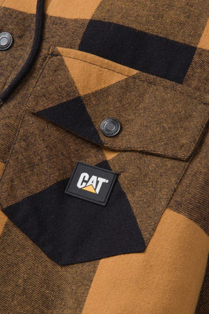 Close-up of the CAT Hooded Flannel Shirt Jacket featuring brown and black plaid, a front flap pocket with black snap button, and a rectangular CAT logo patch on the pocket.