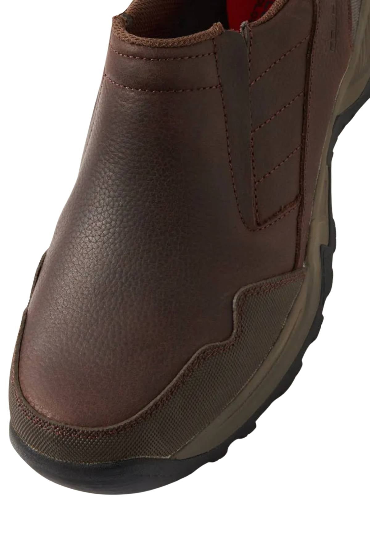 Close-up view of the Colorado Joao Casual Shoe, a brown slip-on with textured leather and fabric, visible stitching, and a rugged Sure Grip Outsole.