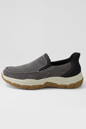 The Colorado Kanza Canvas Shoe is a gray, hands-free shoe featuring a textured fabric upper, black collar, and thick tan slip-resistant rubber sole, displayed in side profile against a plain light background.