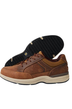 The Colorado Reach Lace Up Shoe is a pair of brown men’s leather shoes with beige soles, dark brown accents, and textured detailing. One shoe stands upright, the other tilts to reveal a black slip-resistant, patterned sole.