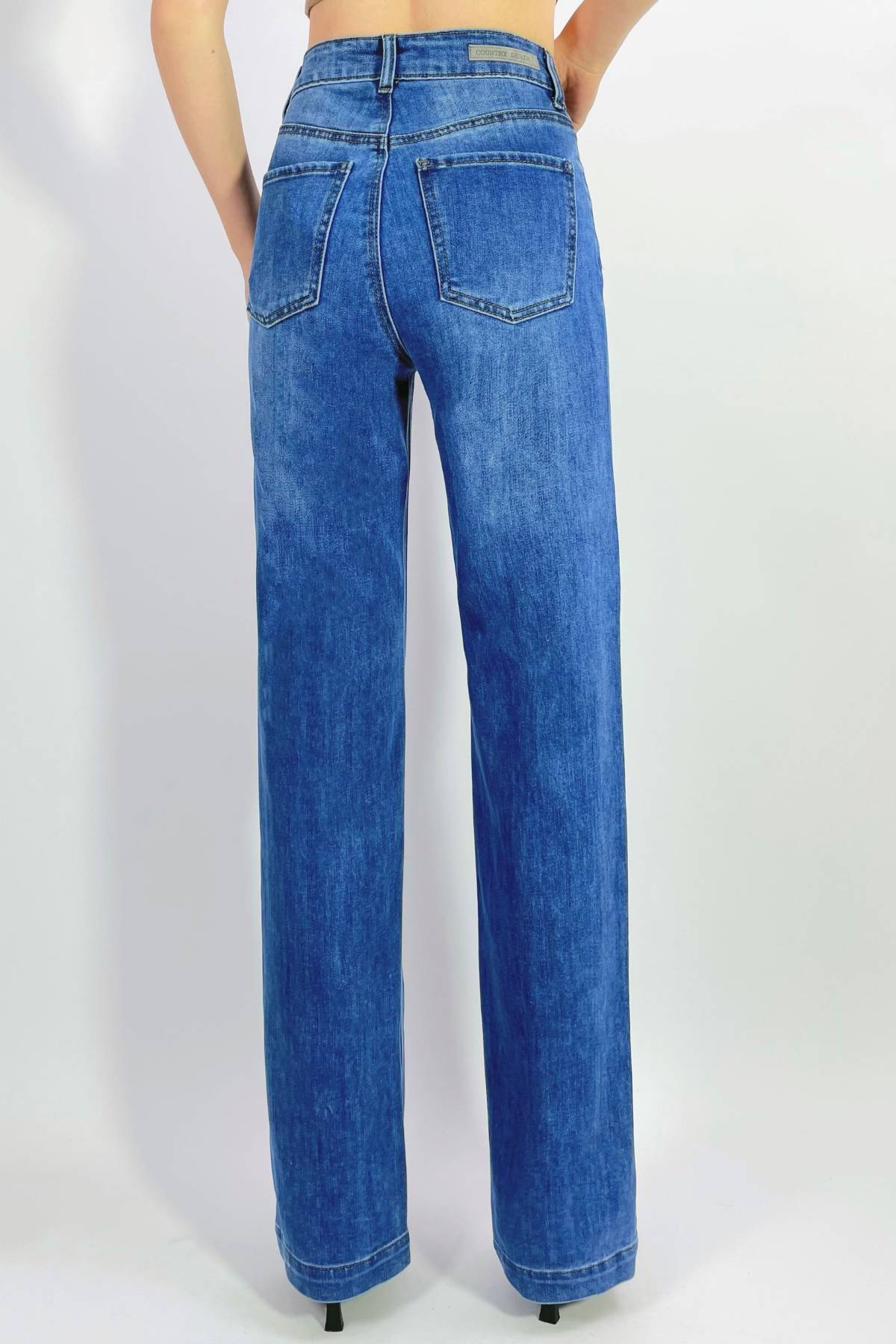 A person stands with their back to the camera, wearing Country Denim Straight Leg Stretchy Jeans—featuring two classic back pockets—and black shoes, set against a plain light background.