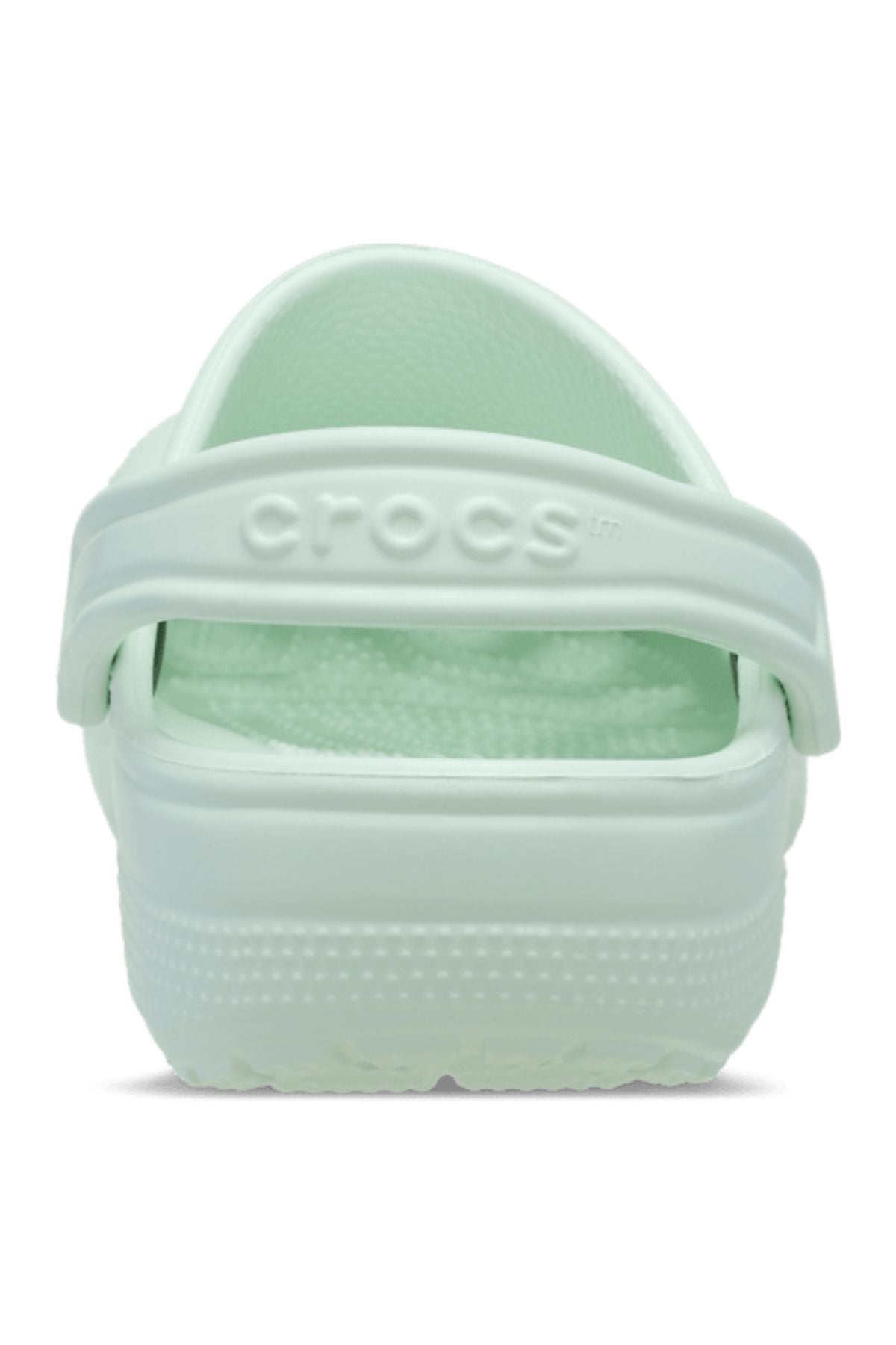A rear view of the Crocs Classic Clog in light mint green showcases its heel strap featuring the embossed Crocs logo—a lightweight, breathable shoe designed for all-day comfort.