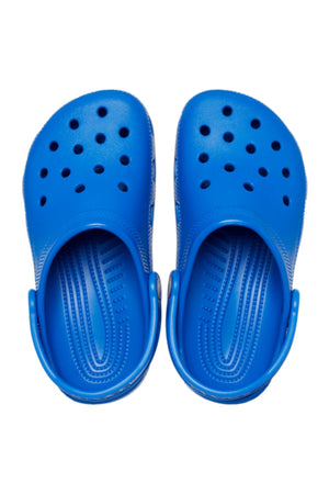 A pair of Crocs Classic Kids Clog in bright blue, featuring ventilation holes and adjustable heel straps for signature Crocs comfort, shown from above on a white background.