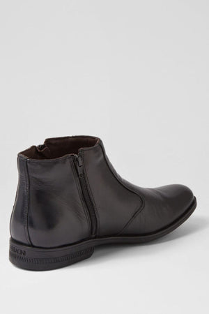 The Ferracini March Boot, crafted in black genuine leather with a side zipper, low heel, and round toe, is the perfect men's zip boot—shown against a plain light gray background.