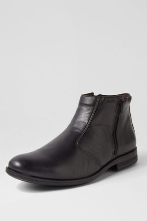 A single Ferracini March Boot, made from genuine leather with a side zipper, low heel, and smooth finish, is shown against a plain light gray background.