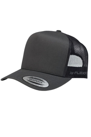 The FlexFit Trucker Cap has a black front panel, curved bill, black mesh back, and an adjustable snapback for a perfect fit. A silver "Snapback" sticker accents the bill.