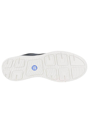 The image displays the white rubber sole of a Florsheim Kore City Pass Sneaker with a geometric tread, blue circular center logo, and a Comfort Gel heel pod for extra cushioning.