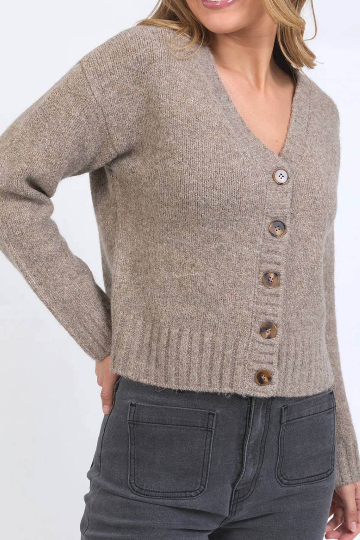 A woman models the Foxwood Jensen Button Cardi with large tortoiseshell buttons and dark gray high-waisted jeans, shown from the waist up against a plain background.