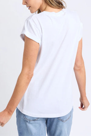 A person is shown from the back, wearing the Foxwood Manly Tee and light blue jeans, standing against a plain light background.