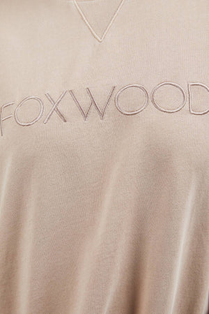 Close-up of the beige, 100% cotton Foxwood Simplified Crew, showcasing tonal "FOXWOOD" embroidery across the front.