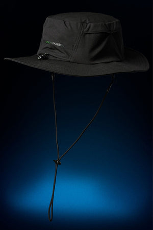The FXD CP-14 Boonie Hat, a black wide-brim hat with chin strap, pocket, and subtle “DESIGN BY DESIGN” text on the front, is shown against a dark blue gradient—ideal for outdoor work and sun protection.