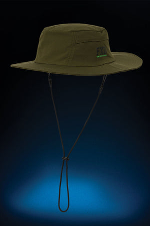 The FXD CP-14 Boonie Hat in olive green features side vents, a chin strap, and "FXD" embroidery on the front—ideal for sun protection during outdoor work. Shown against a dark background with a blue spotlight below.