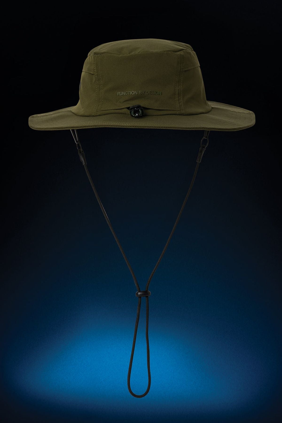 The FXD CP-14 Boonie Hat in olive green provides sun protection, features a wide brim and an adjustable chin strap, and is displayed against a dark background with a blue gradient at the bottom.