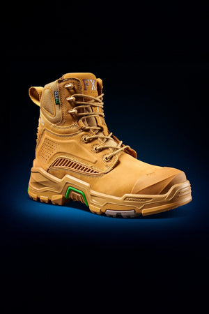 The FXD Dura X-1 Nitrocore™ High Cut, High Performance Work Boot in tan with a rugged sole, green and orange accents, and detailed stitching is shown on a dark background from a front and side angle.