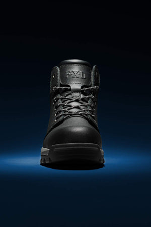 The FXD WB-3 Work Boot, featuring a high ankle design and laces, is presented against a dark background with a subtle blue light below. The sturdy boot, made from premium black leather, suggests it's designed for rugged use or outdoor activities.