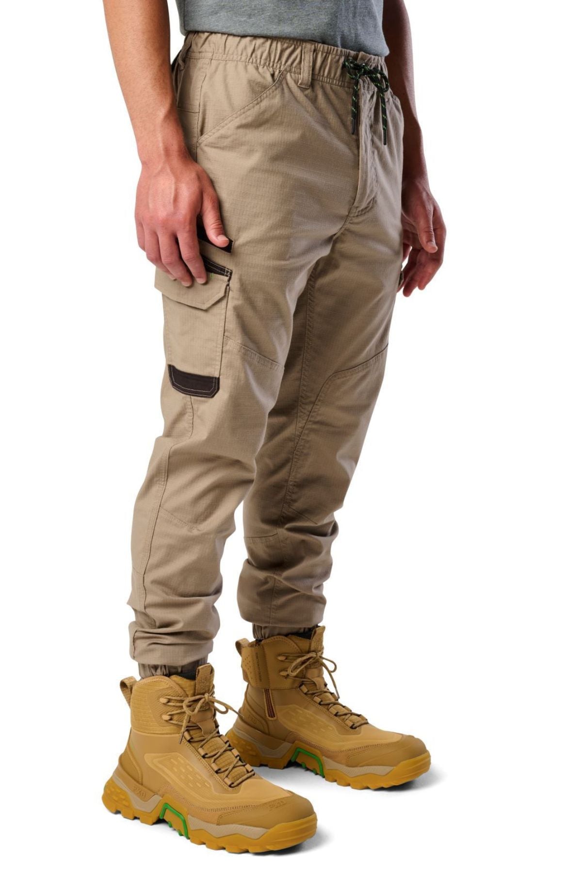 Someone is wearing FXD WP-12C stretch ripstop work pants with brown boots.
