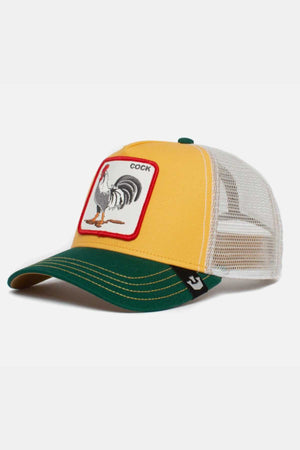 The Goorin Bros The Cock Cap features a bold yellow and green design with a white mesh back, showcasing an embroidered patch of a rooster and the word "COCK" on the front panel.