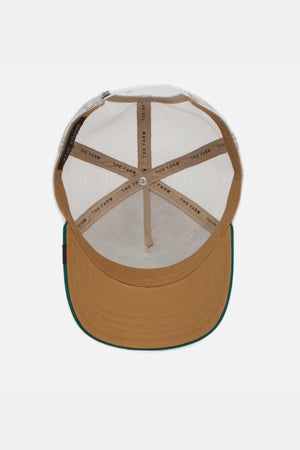 The inside of the Goorin Bros The Cock Cap features a stylish brown and beige design with a green brim, breathable mesh back, and "THE FARM" label on the inner bands for authenticity.