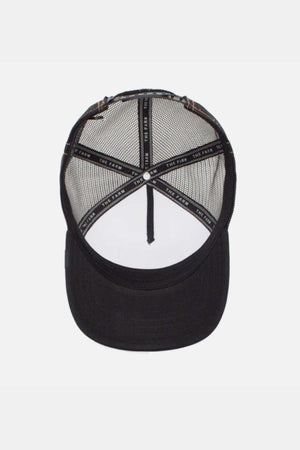 A black mesh baseball cap, named Goorin Bros The King Lion Cap, is shown from the underside, highlighting the interior structure and stitching. This trucker cap features a curved brim with reinforcing strips inside labeled with text. The mesh back ensures breathability, and the hat is unadorned on the underside.