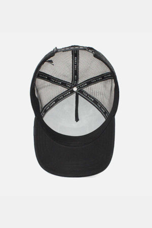 The Goorin Bros The Lone Wolf Cap is displayed from the front, showcasing its mesh back and solid black front panel. Inside, a label is visible along the inner seams, and it features a snap back for adjustable comfort.