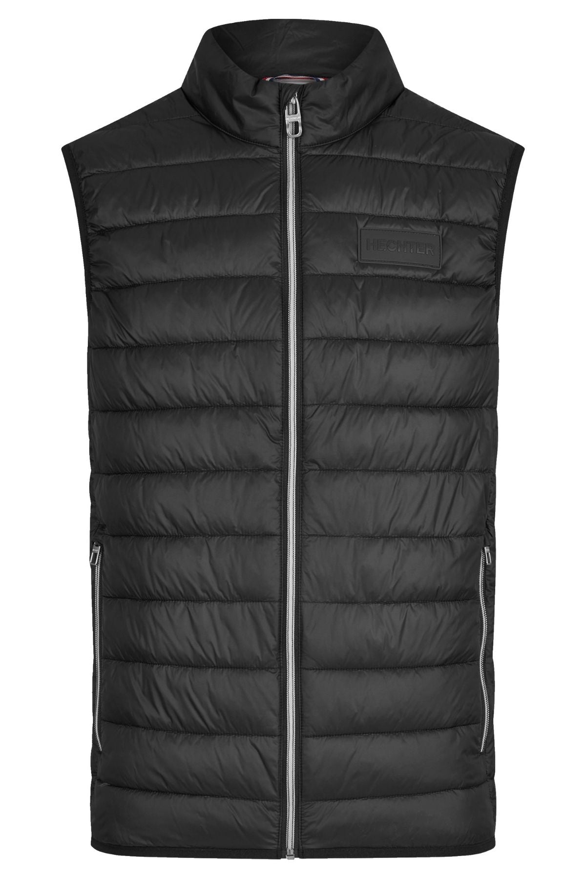 The Hechter Puffer Vest is a black, sleeveless puffer with horizontal quilting, a high collar, front zipper, zippered side pockets, and a small rectangular rubber logo patch on the left chest.