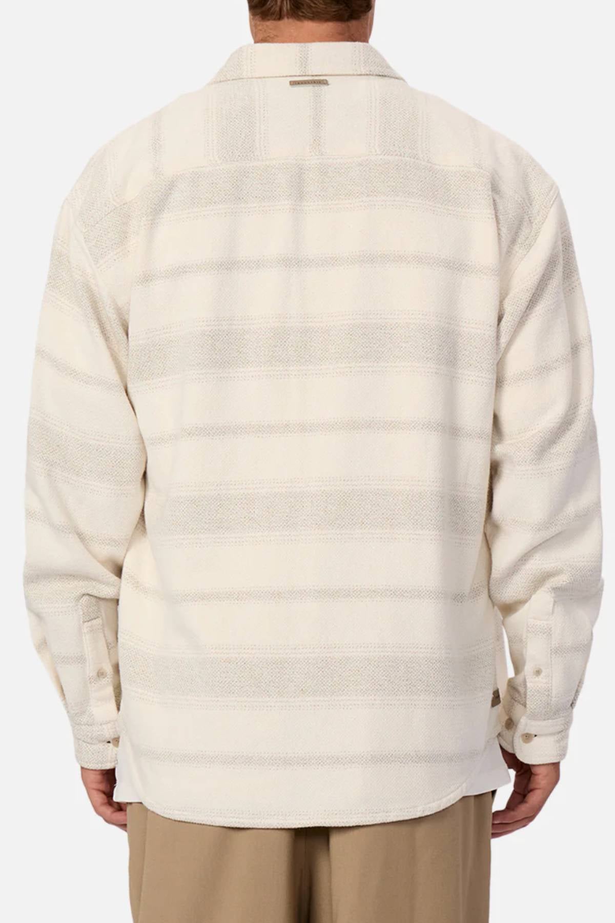 A person is seen from the back wearing the Industrie The Arizona Long Sleeve Shirt in light beige and cream stripes with tan pants. This classic fit shirt features buttoned cuffs and is made from 100% cotton.