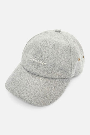 The Industrie Claude Cap is a light gray wool blend hat with "Industrie" embroidered in white, a curved brim, side ventilation eyelets, and an adjustable strap for comfort.