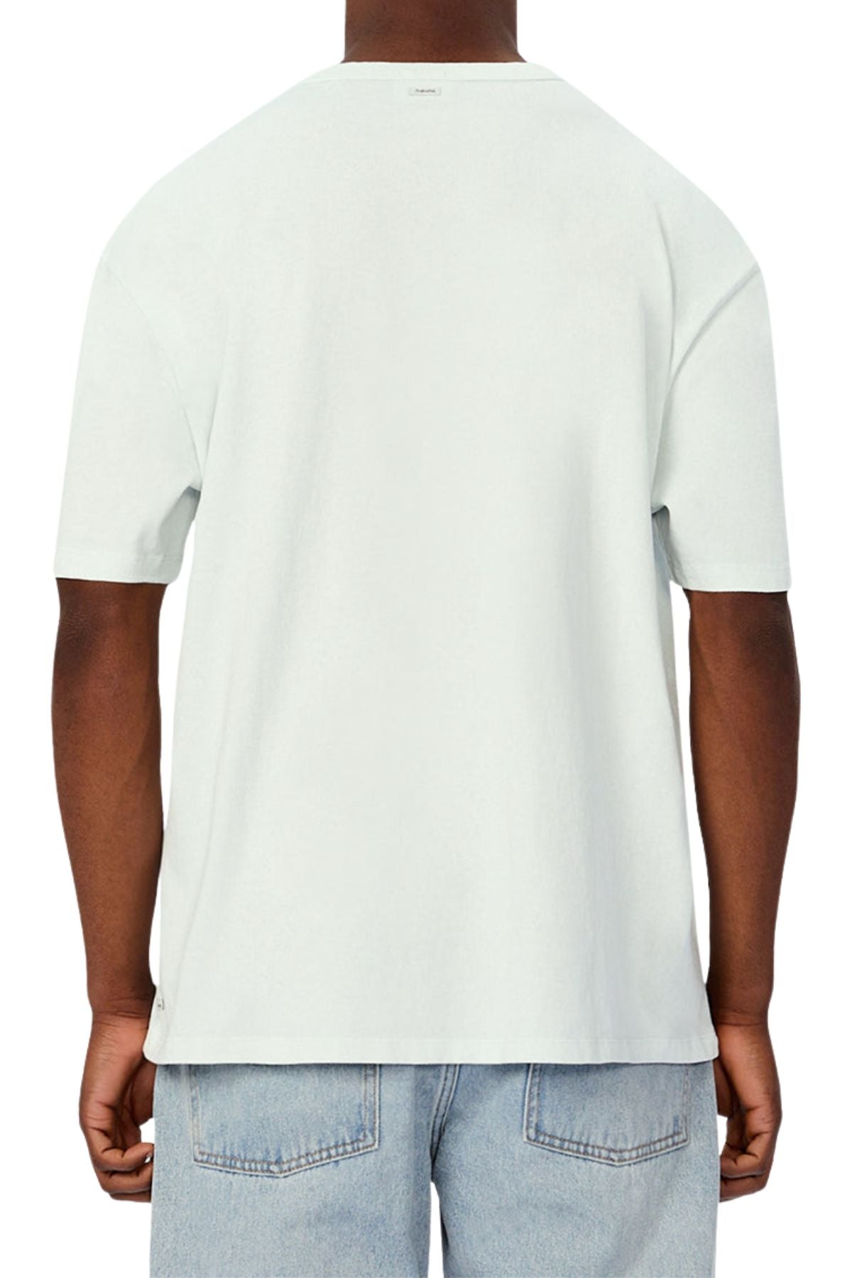 A person is seen from the back wearing an Industrie The Del Sur Tee in plain light gray with short sleeves and a relaxed, oversized fit, paired with light blue jeans against a white background for a casual look.